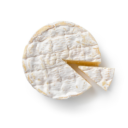 Traditional single French Camembert cheese and a piece seen from above isolated on white background
