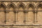Ancient gothic stone wall with arches and columns in York, England, UK