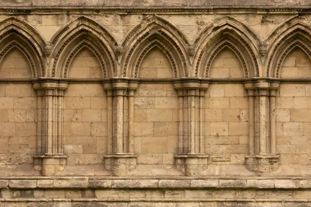 Photo of Ancient gothic stone wall with arches and columns in York, England, UK