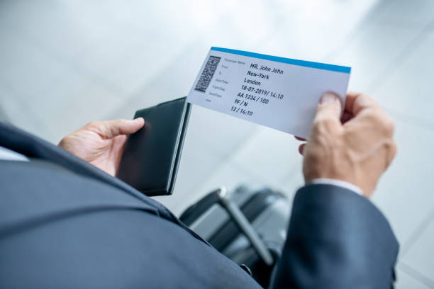 istock Male hands holding passport and plane ticket 1338092586
