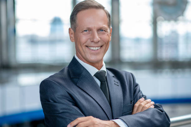 Smiling business man standing at airport