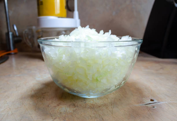 finely cut onions in a glass bowl on a light table
