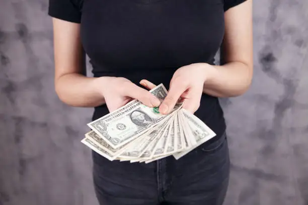 young woman holding money in her hands