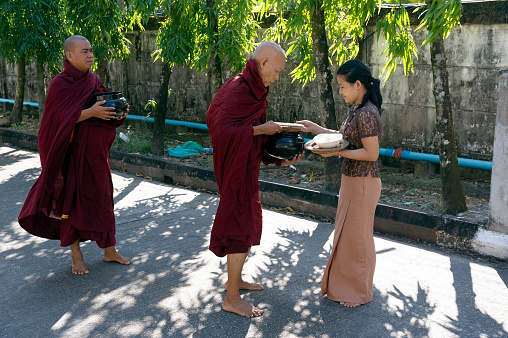 Myanmar. Yangon (Rangoon). Gathering of alms by the Buddhist monks early in the morning