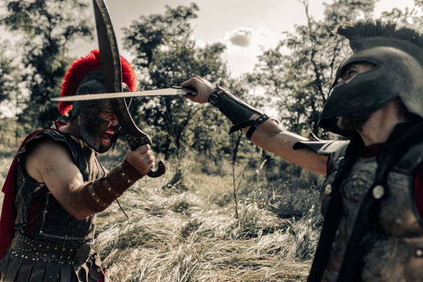 istock Battle with swords between two ancient warriors on meadow. 1338094194