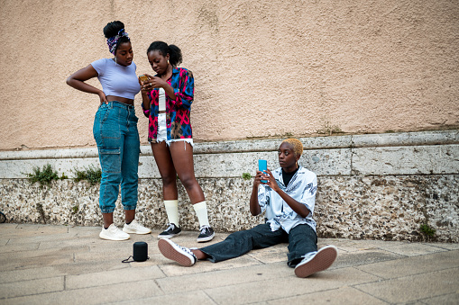 Three young women using mobile phone