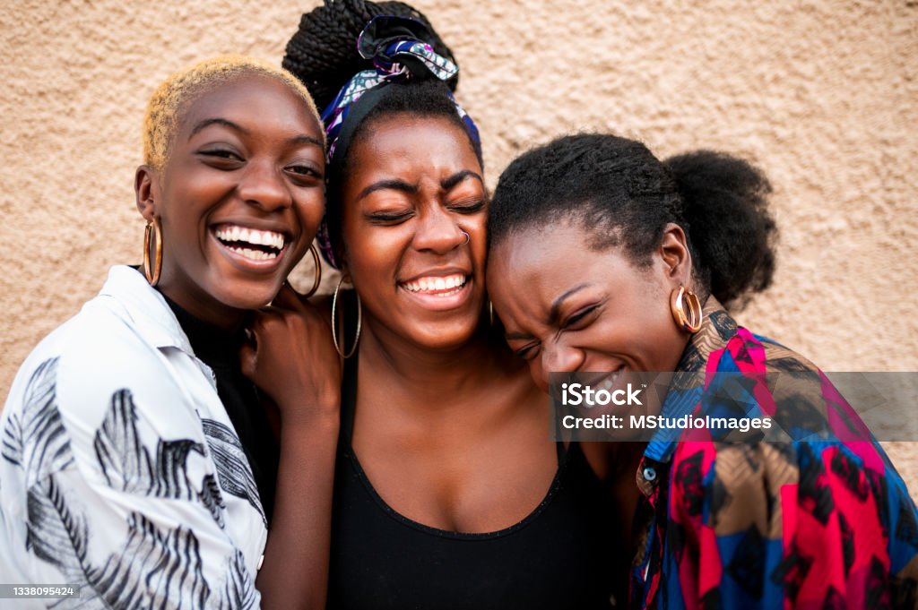 Portrait of three smiling women Three beautiful women laughing African Ethnicity Stock Photo