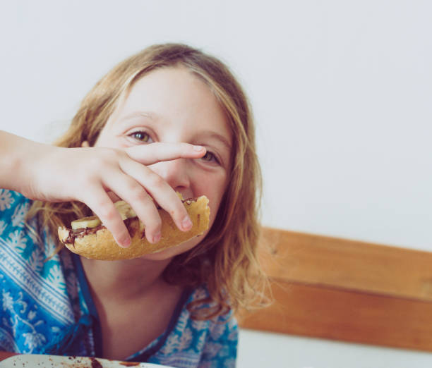 istock Cute girl eats a snack in a stylish cafe 1338095510