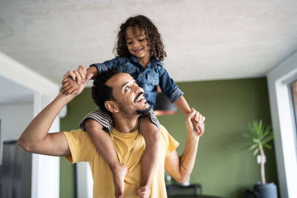 istock Father carrying son over shoulders at home 1338096439