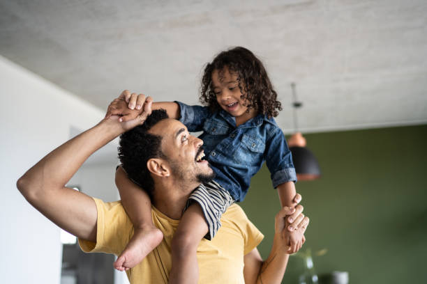 istock Father carrying son over shoulders at home 1338096449