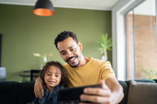 istock Father and son watching something or doing a video call on smart phone at home 1338096498