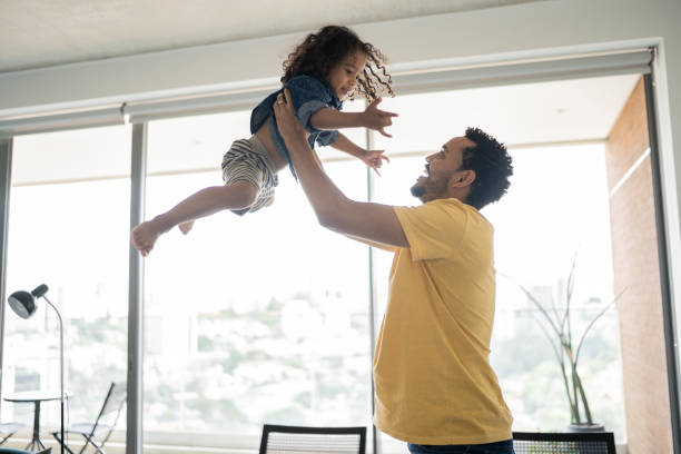istock Father playing with son at home 1338096546