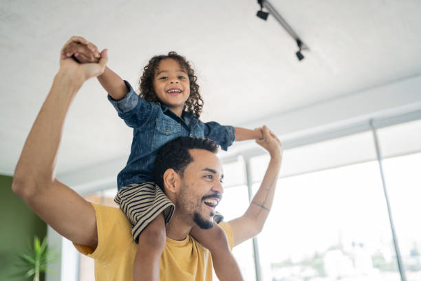 istock Father carrying son over shoulders at home 1338096575
