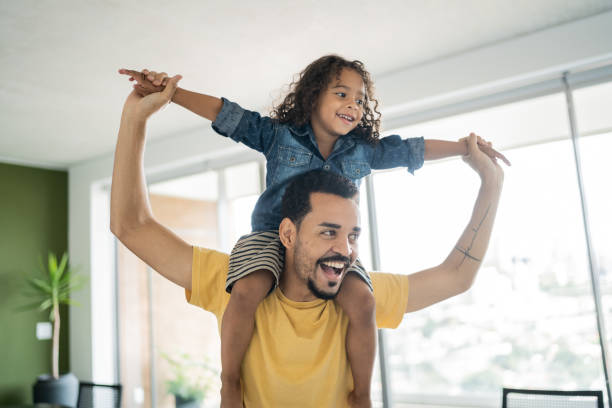 istock Father carrying son over shoulders at home 1338096589