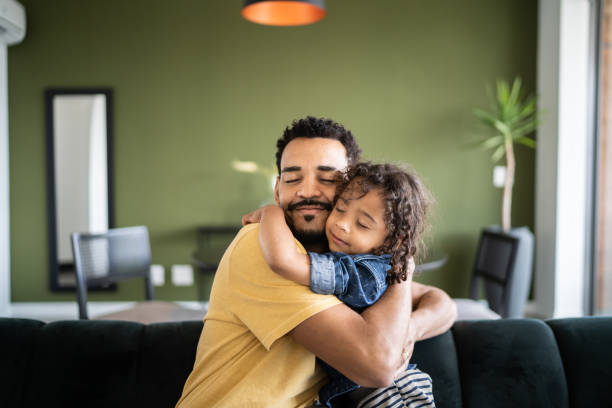istock Father and son hugging each other at home 1338096868