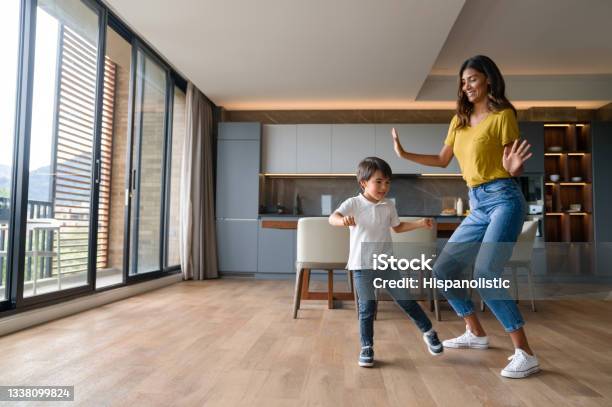 Happy Mother Having Fun Dancing With Her Son At Home Stock Photo - Download Image Now
