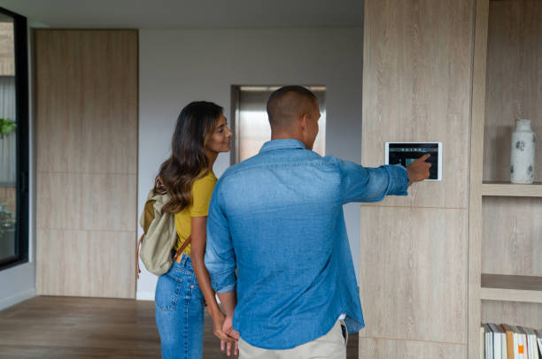 istock Couple leaving their house and locking the door using a home automation system 1338099874