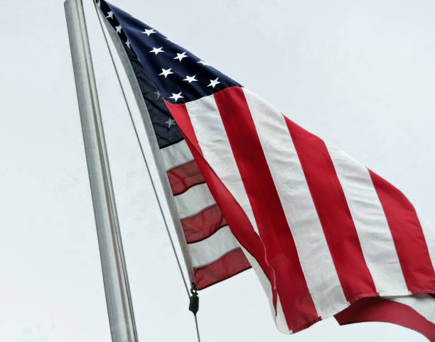 istock American Flag Hanging From Flagpole 1338103123