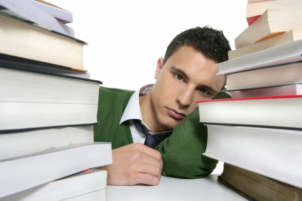 istock Young unhappy student with stacked books 1338105768