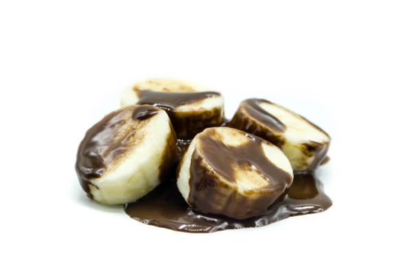 istock Bananas with chocolate sauce isolated on white background 1338105945