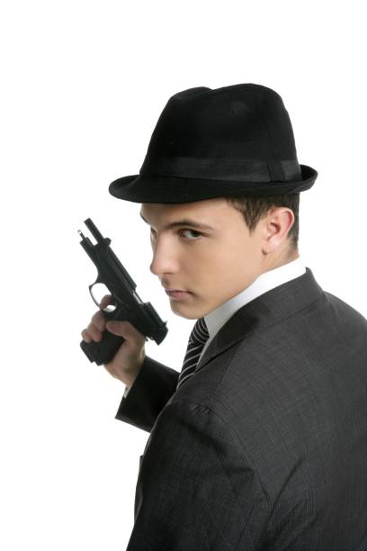 istock Classic mafia portrait, man with black suit and gun 1338106277