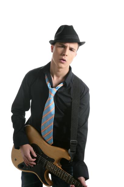 istock young sexy male guitar player, tie and black hat 1338107324