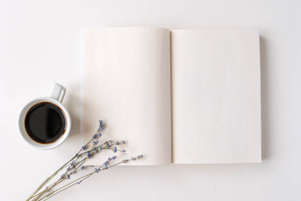 istock Opened notepad, book with white blank sheets on a desk. Hot black coffee, dry lavender bouquet. Morning mood, space for text 1338108442