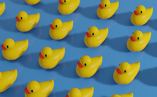 Isometric view of some yellow rubber ducks moving together. Working as a team. Teamwork concept