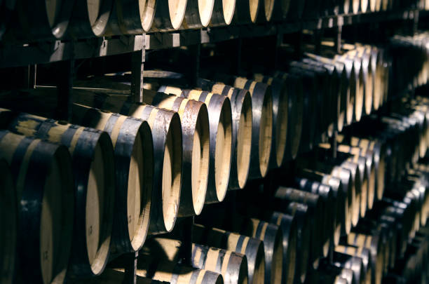 botti di vino o whisky impilate in cantina - alcohol wine barrel la rioja foto e immagini stock