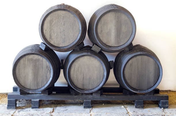 Former black barrels stacked in pyramid stock photo