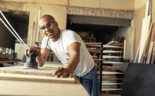 Portrait of young black man carpenter in his workshop. stock photo