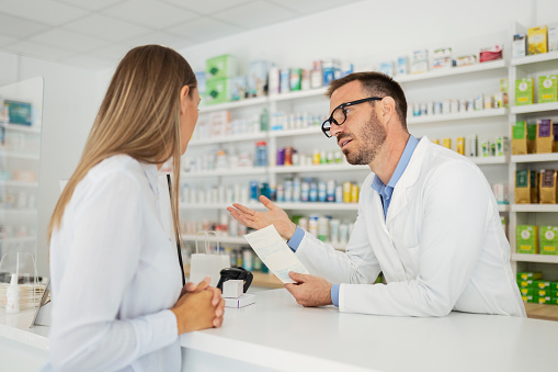 Pharmacist  explaining drug in pharmacy