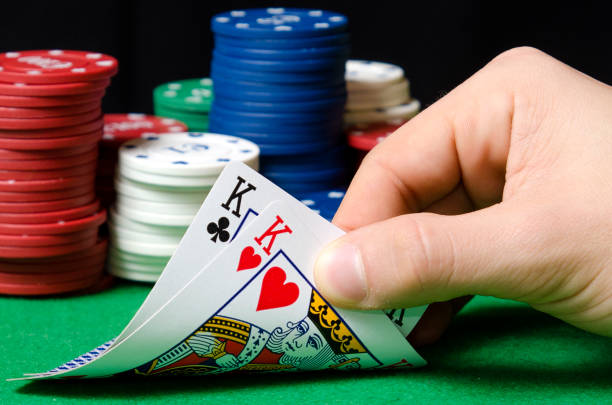 istock Close-up of hands with poker cards 1338113564