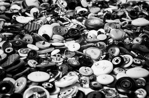 Many sewing buttons in black and white stacked