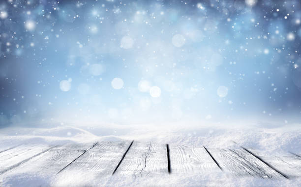 istock Flakes of snow fall and sparkle on light. 1338114865