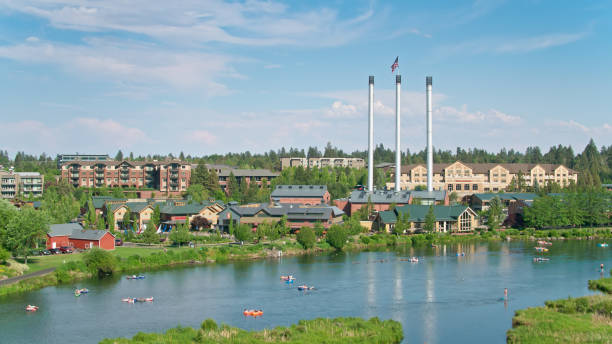 istock Drone Flight Over Deschutes River Towards Old Mill District Smokestacks in Bend in Summer 1338118525