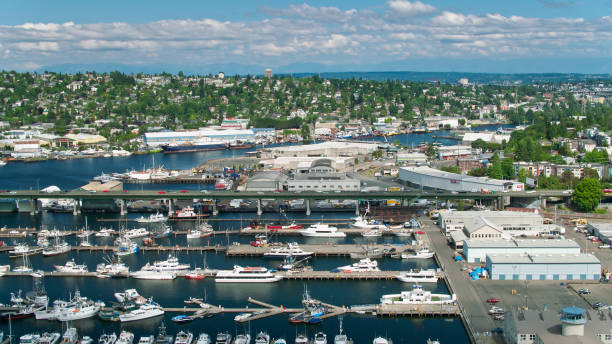 Drone Shot of Ballard Bridge Carrying Traffic Over Moored Boats and Across the Lake Washington Ship Canal Aerial shot of Seattle, Washington on a sunny day in summer, looking down on the Lake Washington Ship Canal between North Queen Anne and Ballard. ballard-seattle stock pictures, royalty-free photos & images