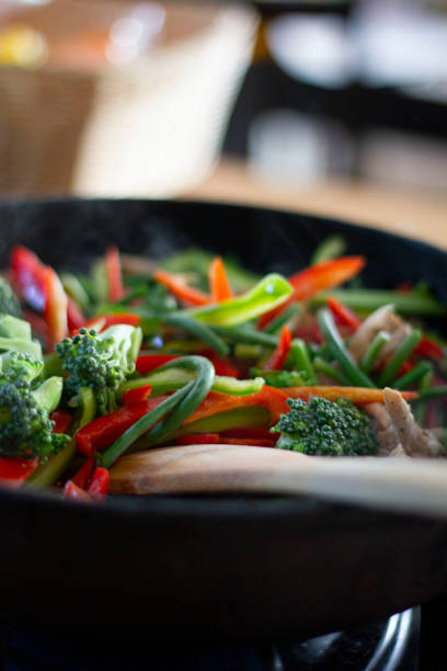 istock Cooking vegetables in a frying pan. Broccoli, carrots, string beans on cast iron frying pan. Vegetarian Food. 1338118731