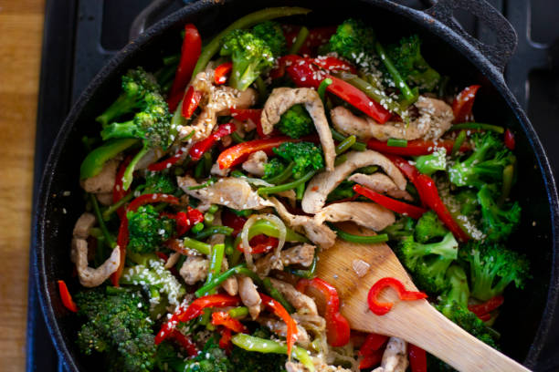 istock Cooking vegetables in a frying pan. Broccoli, carrots, string beans on cast iron frying pan. Vegetarian Food. 1338118732