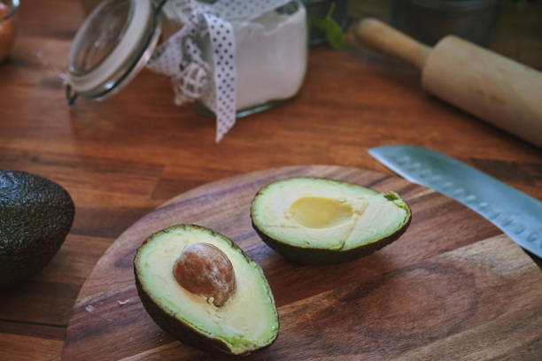 istock Cutting Avocado on Wooden Board 1338121965