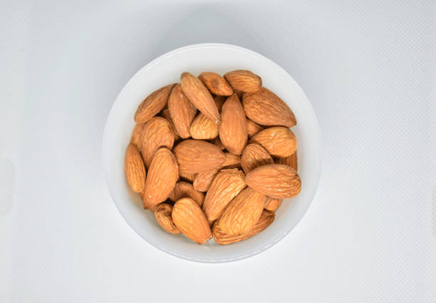 istock Bowl Of Almonds Nuts on white background. 1338125469