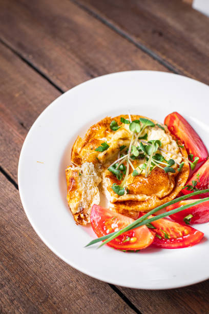 istock omelet with vegetables fresh breakfast fried eggs and tomato, cucumber fresh portion ready to eat meal snack on the table copy space food background rustic keto or paleo diet veggie 1338128447