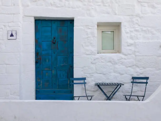 Romantic chairs and table set in historic city center of Ostuni, Puglia