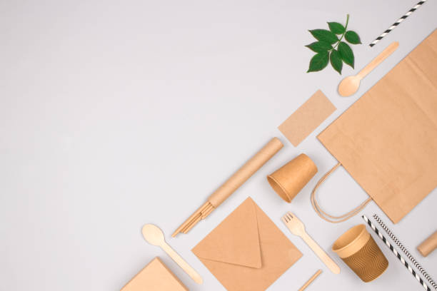 istock Flat lay composition with eco-friendly tableware - kraft paper food packaging on light gray background with copy space. Street food paper packaging, recyclable paperware, zero waste packaging concept 1338134290