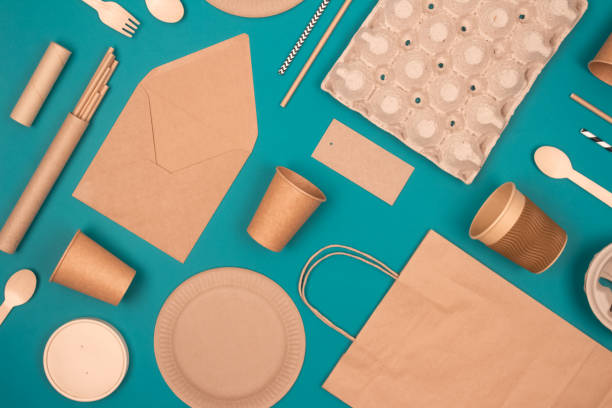 istock Flat lay with eco-friendly tableware and sustainable packaging. Kraft paper food packaging on green background. Street food paper packaging, recyclable paperware, zero waste packaging concept 1338134291