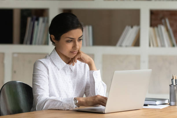 istock Serious thoughtful Indian woman working on laptop 1338134326