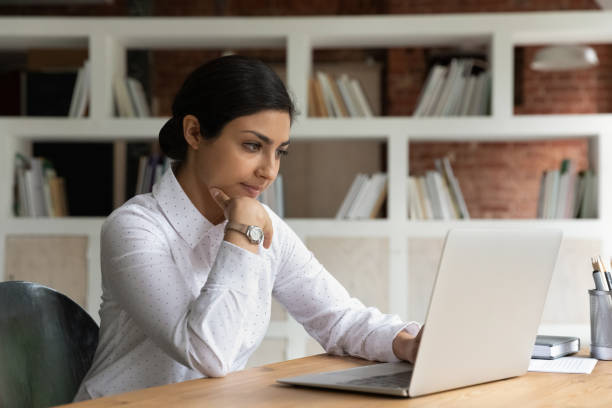 poważna rozmyślająca indyjska bizneswoman pracująca nad projektem on-line - computer computer monitor women business person zdjęcia i obrazy z banku zdjęć