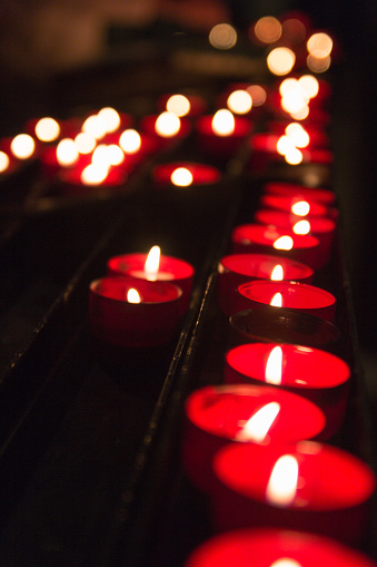 Burning candles shot with shallow depth of field on black background