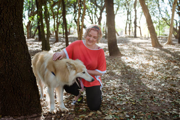 istock Woman and her pet doing trail in forest during sunset 1338141403
