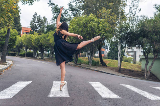 istock Ballet dancer performing graceful figure dance on one leg with pointe shoes 1338141978